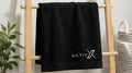 ACTIVX Bath Towel in Black — rack view