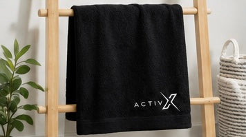 ACTIVX Bath Towel in Black — rack view